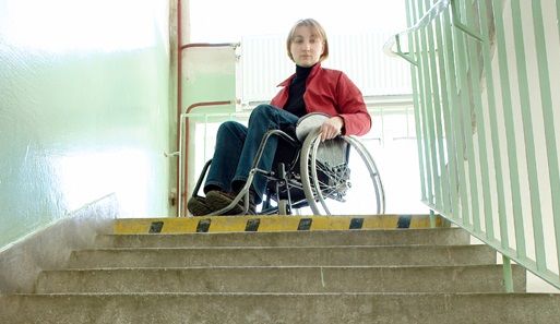 Person in a wheelchair looking down flight of stairs