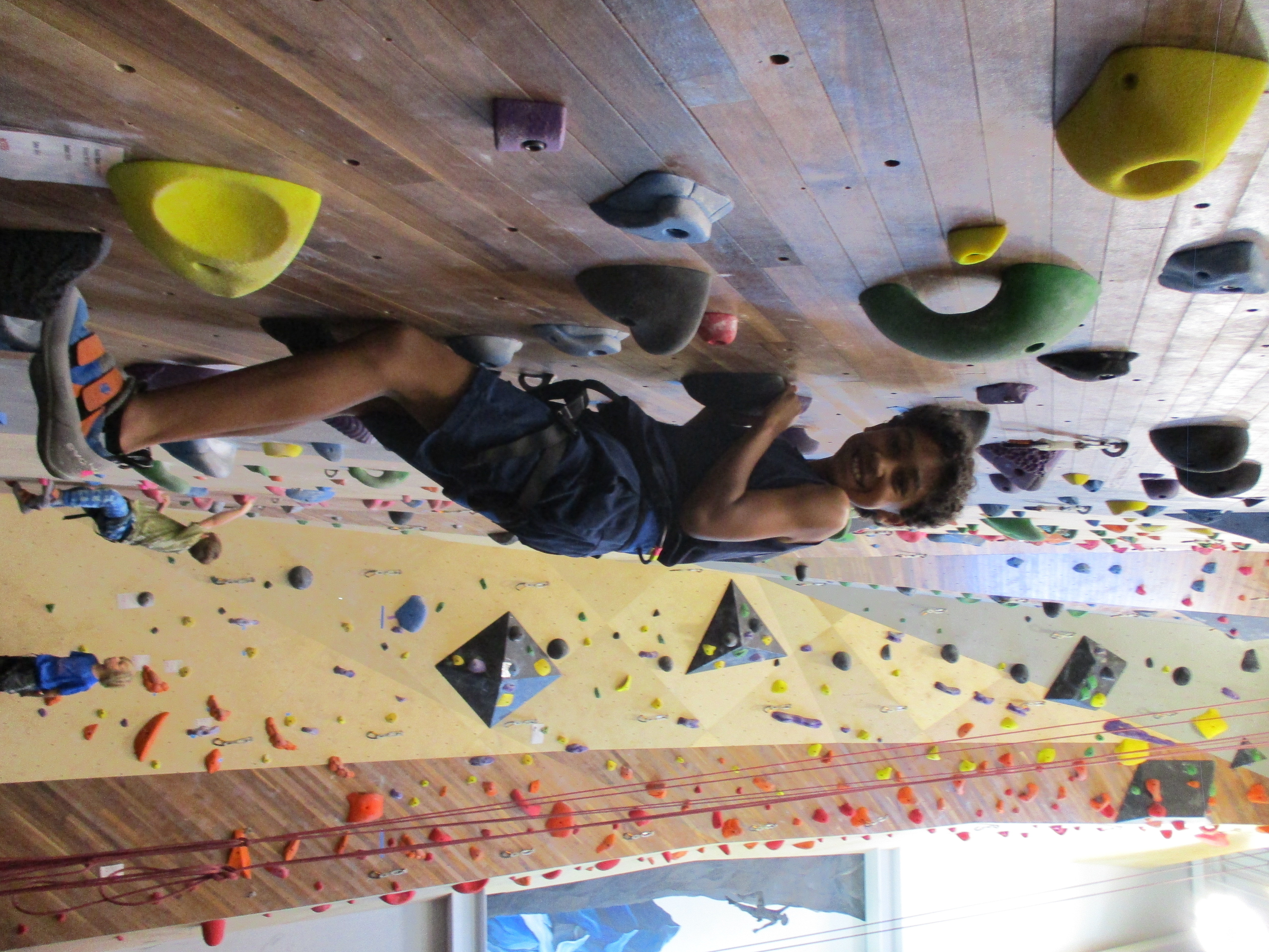 young student climbing smiling