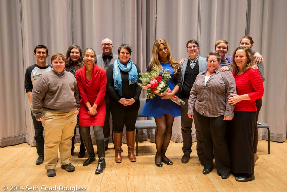 Picture of members of the Gender, Sexuality, and Women's Studies Department Council standing with actress Laverne Cox who is holding a bouquet of flowers.