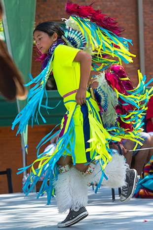 A student in Native regalia during powwow in 2015